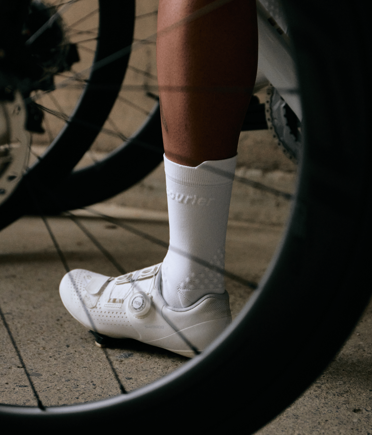 HiFi socks on cyclist behind wheel