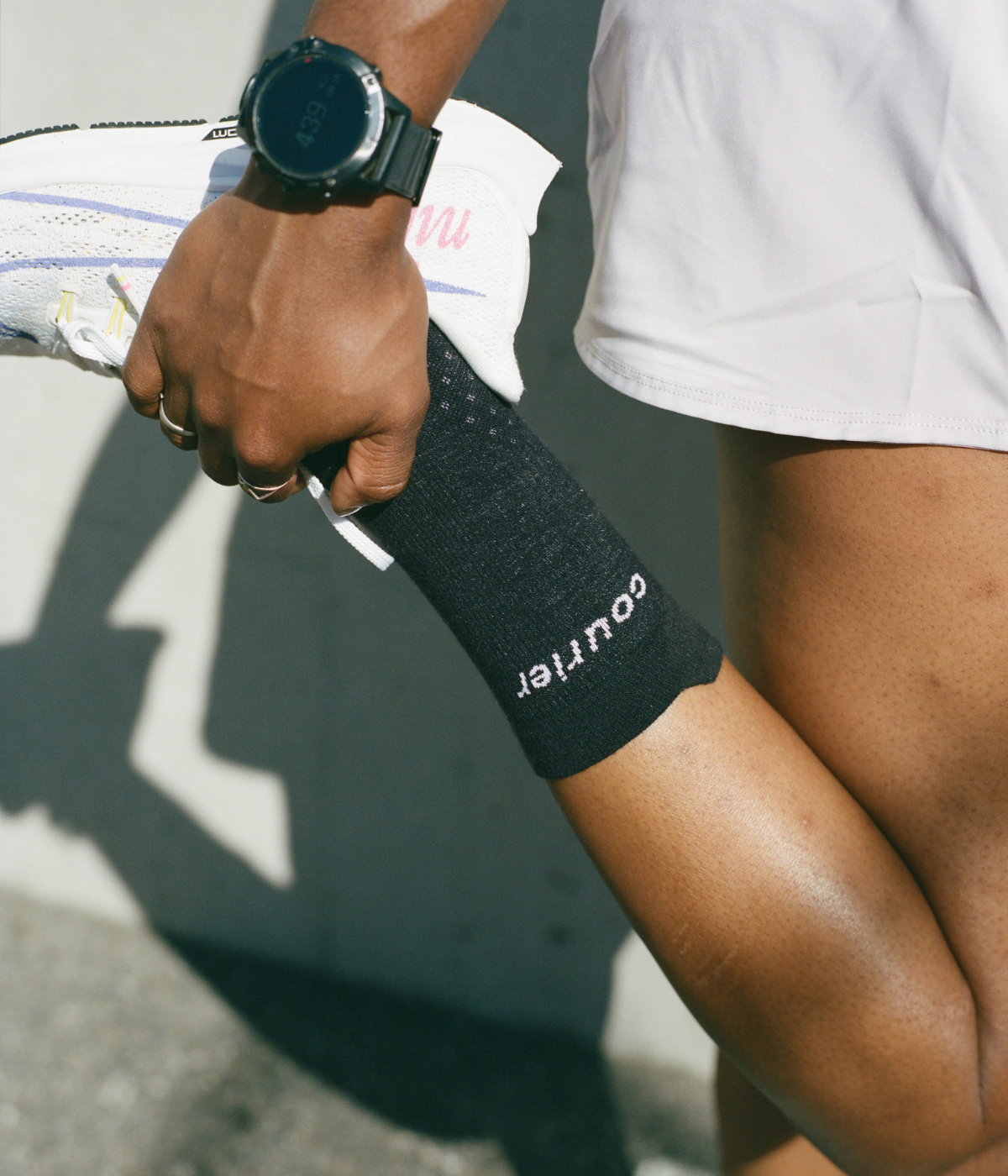 Runner stretching wearing Courier LoFi black socks